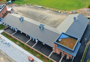 Multi-discipline project with pitched, flat, hard metal and green roof elements